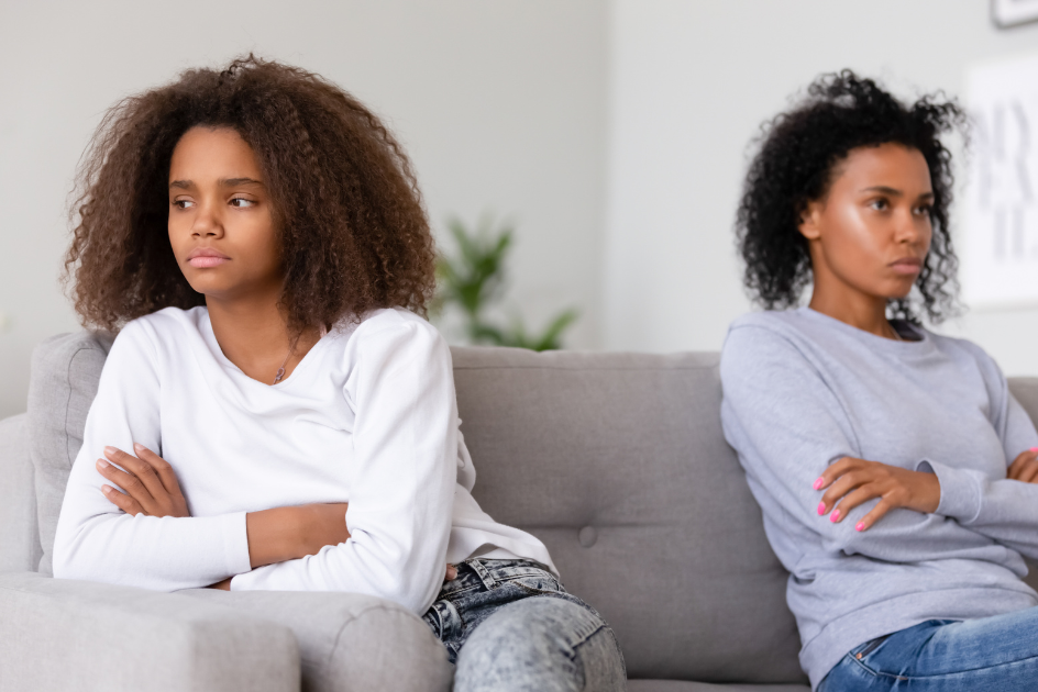 mother and daughter facing away from each other, scowling